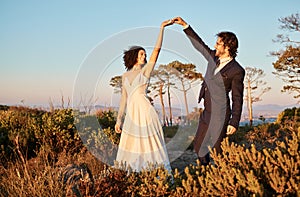 Love, wedding and holding hands for dance with couple in nature park for celebration, romance and happiness. Sunset