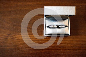 Love Wedding Rings on the Brown Wood Table