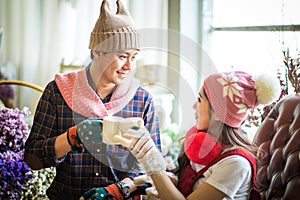 love, wedding, winter, dating and people concept - smiling couple in coffee Time.