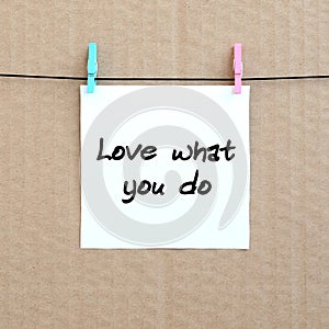 Love what you do. Note is written on a white sticker that hangs