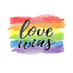 Love wins hand drawn lettering quote. Homosexuality slogan on watercolor rainbow background. LGBT rights concept. Modern