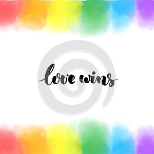 Love wins. Inspirational LGBT quote on rainbow hand painted background. Bright texture for pride.