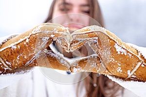 Love winter. Charity. Happy woman shows heart. Woman hands in winter gloves Heart symbol shaped Lifestyle and Feelings