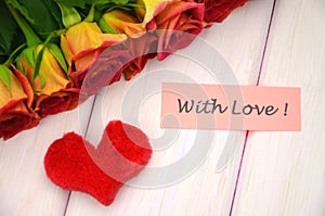 With love wishes and bouquet of gorgeous red roses