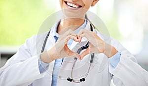 Love, woman doctor with heart sign and with smile at a hospital for healthcare. Medication or health wellness, nurse and