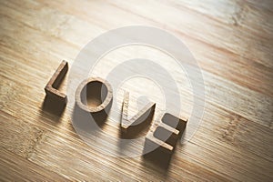 Love wooden letters on rustic wood board background