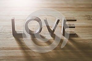 Love wooden letters on rustic wood board background