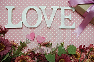 Love word alphabet and roses bouquet with space copy on pink polka dot background