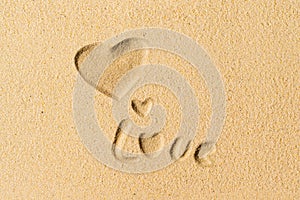 Love word hand-drawn on sand tropical beach. valentines day. Beach holiday concept. Creative, background, copy space, travel