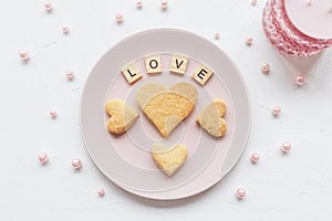 LOVE word and heart shaped cookies on a pink plate