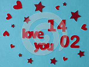 Love word, heart and stars on soft blue paper  background. Top view
