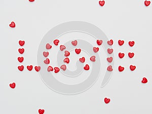 Love word made little red heart on white background for valentine