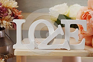 Love word wooden letter with artificial flowers decor