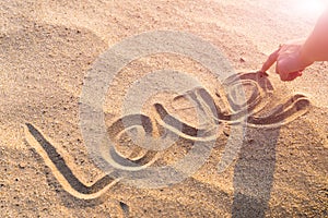 LOVE word writing on the white sand nature on the beach. summer trip