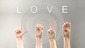 Love word written and shown with hands in deaf asl language, expressing feelings