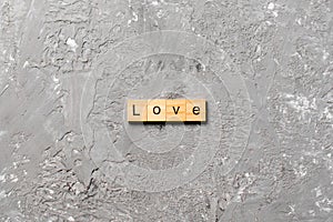 Love word written on wood block. love text on table, concept