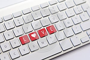 LOVE writing on white keyboard with a heart sketch