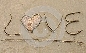 Love written on sandy beach