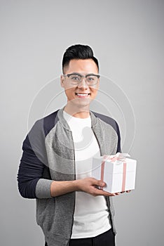 With love for you. Good looking young man holding a gift box and