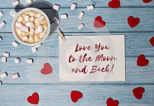 LOVE YOU TO THE MOON AND BACK text on valentine card inscription positive quote phrase. Greeting card with red envelope