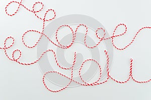 Love you words written with woolen red and white thread lettering, concept and isolated white background for Valentine`s