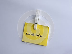 Love you written on clipped yellow note
