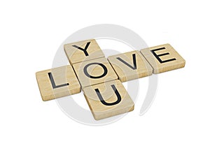 Love You written with wooden letters, isolated on white background