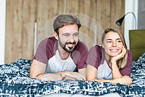 In love young couple lying on bed together