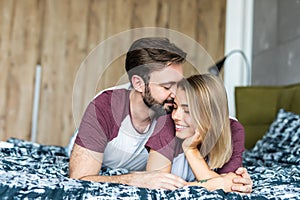 In love young couple lying on bed together