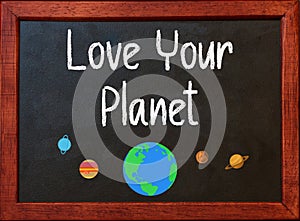 Love Your Planet. Motivational Quote on blackboard