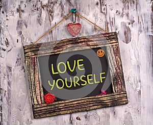 Love yourself written on Vintage sign board