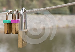 Lovelocks placed by lovers on the wires of a bridge