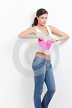 Lovelorn woman with paper heart in hands