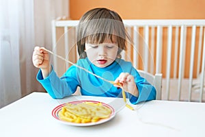 Lovely 2 years boy made macaroni beads at home