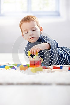 Lovely 3 year old playing with cubes at home