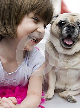 A lovely adorable young child with pug