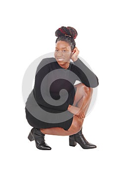 Lovely African woman crouching on floor