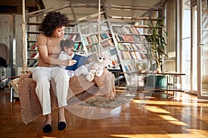 Lovely afro american mother reading bedtime story