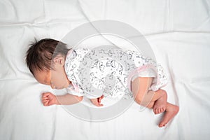 Lovely Asian baby infant sleeping on soft bed. portrait of newborn child.