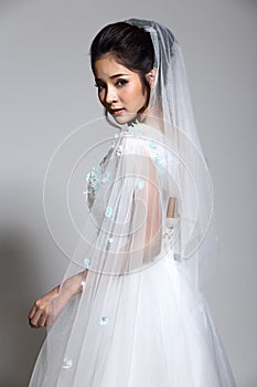 Lovely Asian Beautiful Woman bride in white wedding gown dress w