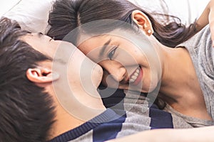 Lovely attractive young Asian couple man kiss forehead of happy woman with and hug in romantic moment. Warm heart marriage and lov