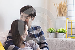 Lovely attractive young Asian smile couple man and woman with happy kiss and hug in romantic moment. Warm heart marriage and lover