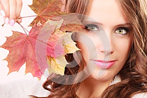 Lovely autumnal girl with maple leaves in hand