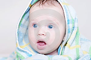 Lovely baby age of 4 months in blue towel