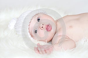 Lovely baby age of 4 months in white knitted hat