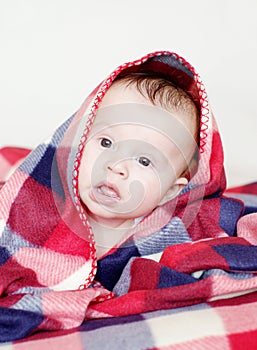 Lovely baby covered by checkered plaid