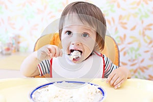 Lovely baby eating quark