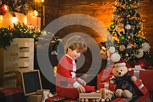 Lovely baby enjoy christmas. Family holiday. Childhood memories. Santa boy celebrate christmas at home. Boy child play