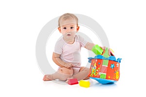 Lovely baby girl playing with toys