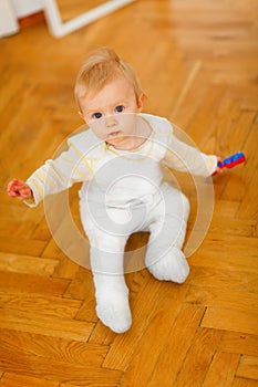 Lovely baby sitting on floor